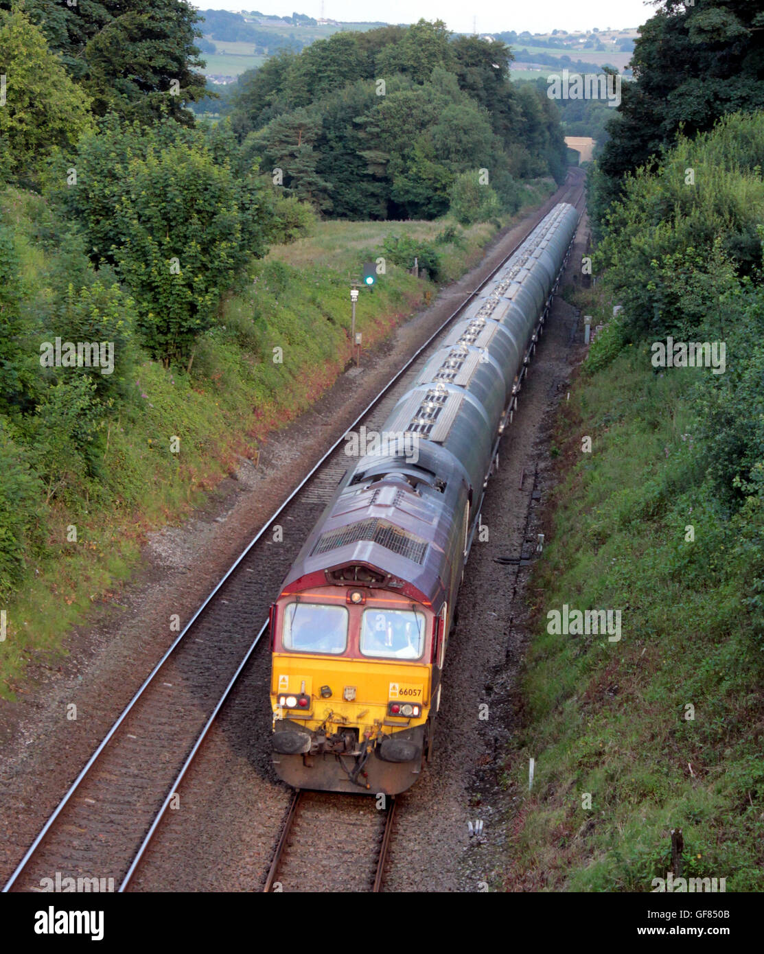 A freight train of loaded cement wagons hauled by a diesel locomotive passes Houghton Bottoms near Blackburn in Lancashire. Stock Photo