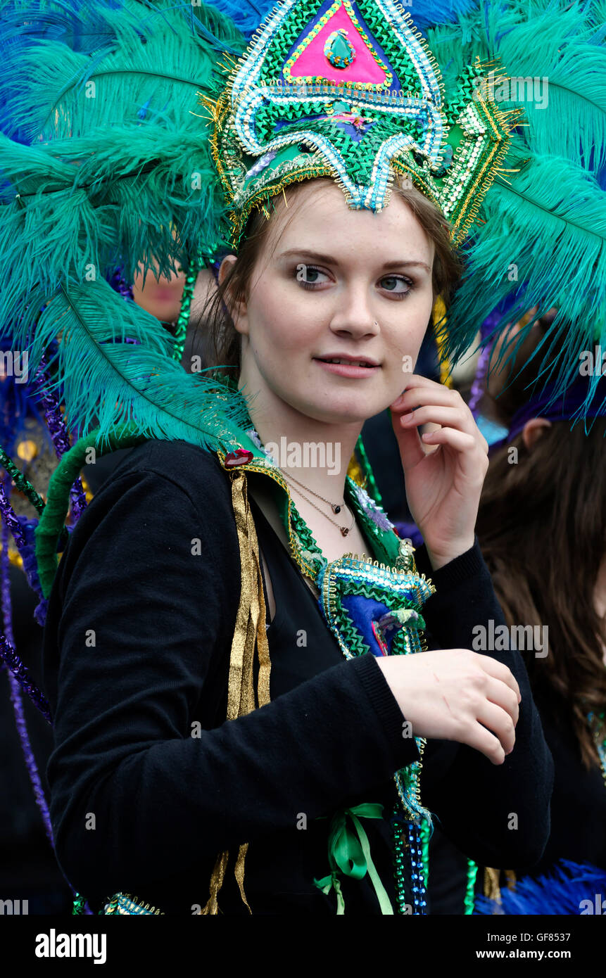 Girl dressed in an exotic feathered costume taking part in the Carnival Parade, part of the Edinburgh Jazz Festival. Stock Photo