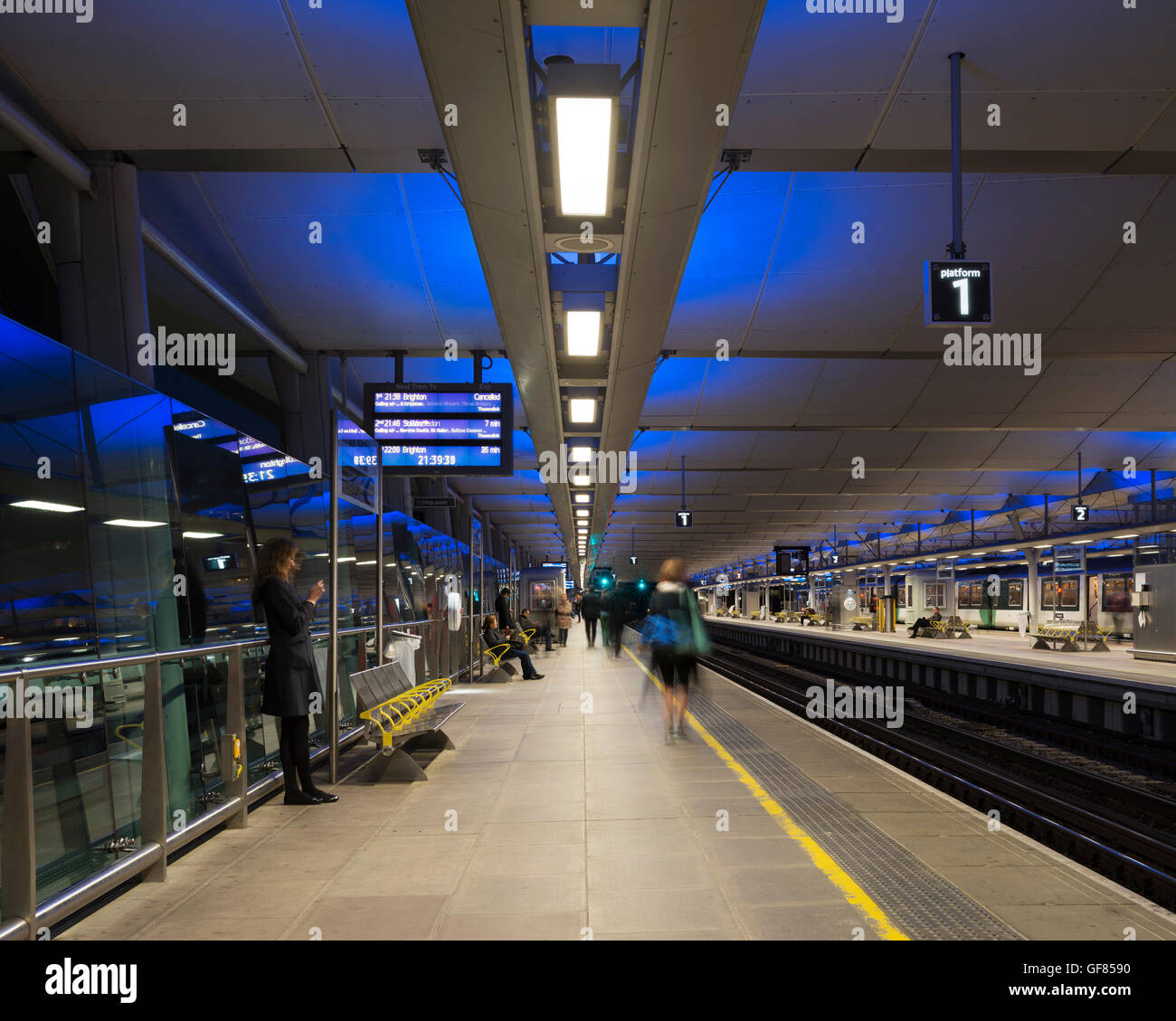 View along platform with passengers. Blackfriars Station, London, United Kingdom. Architect: Pascall+Watson architects Ltd, 2012. Stock Photo