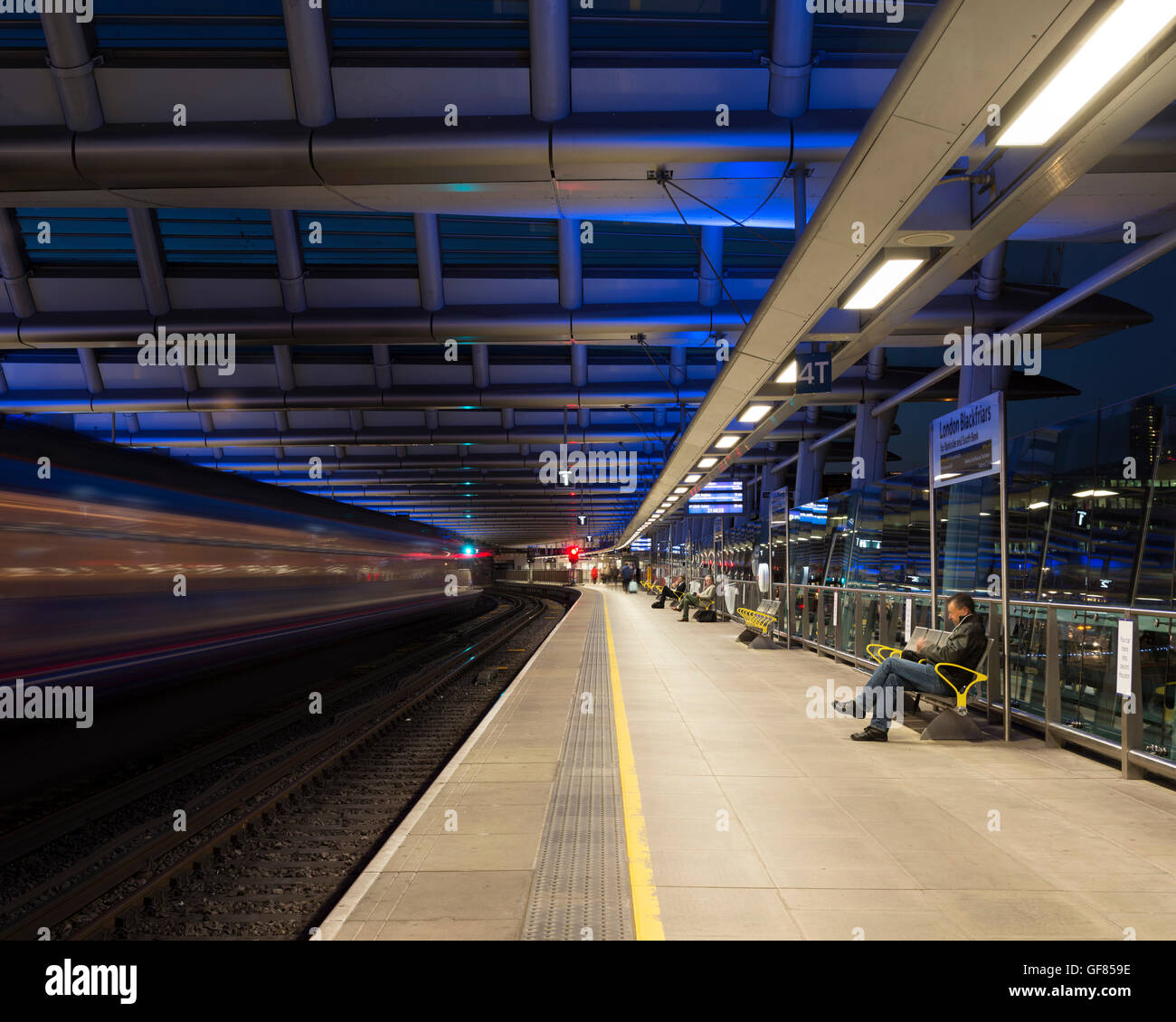 View along platform with passengers. Blackfriars Station, London, United Kingdom. Architect: Pascall+Watson architects Ltd, 2012. Stock Photo