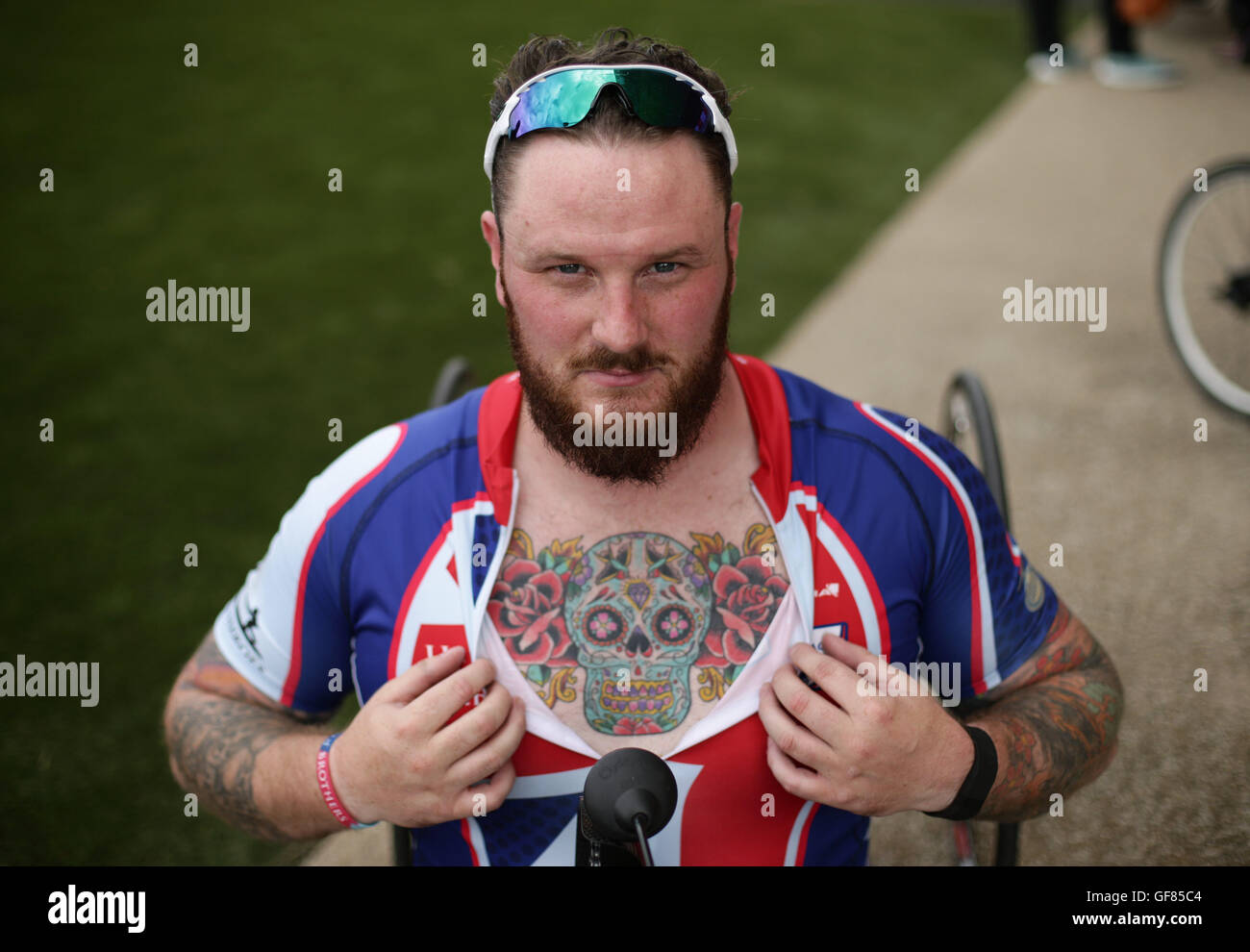 Competitor Clive Smith shows off his chest tattoo during the Prudential RideLondon Grand Prix at the Lee Valley VeloPark, Queen Elizabeth Olympic Park, in London. Stock Photo