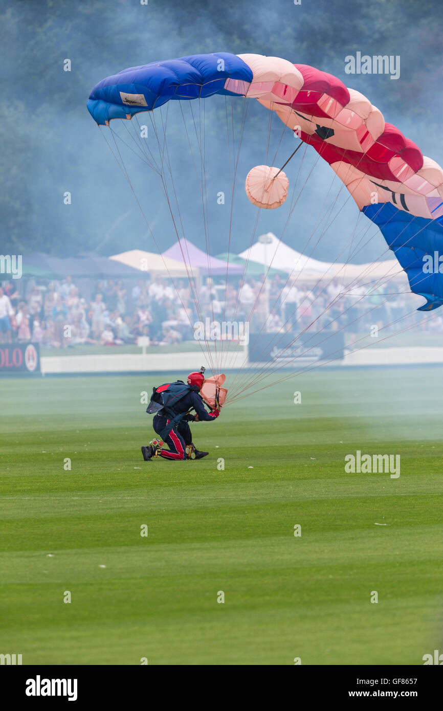 A member of the RAF Falcons parachute display team lands at the 2016 Jaeger Le Coultre Gold Cup final at Cowdray Park. Stock Photo