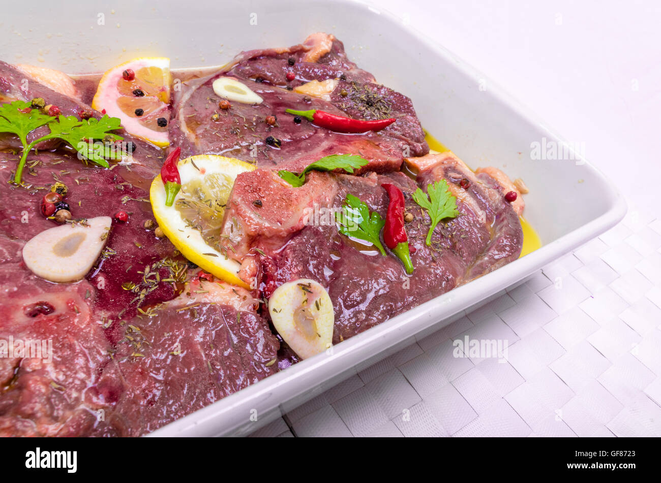 Steaks of red meat , marinated with emulsion of lemon juice and olive oil and seasoned with