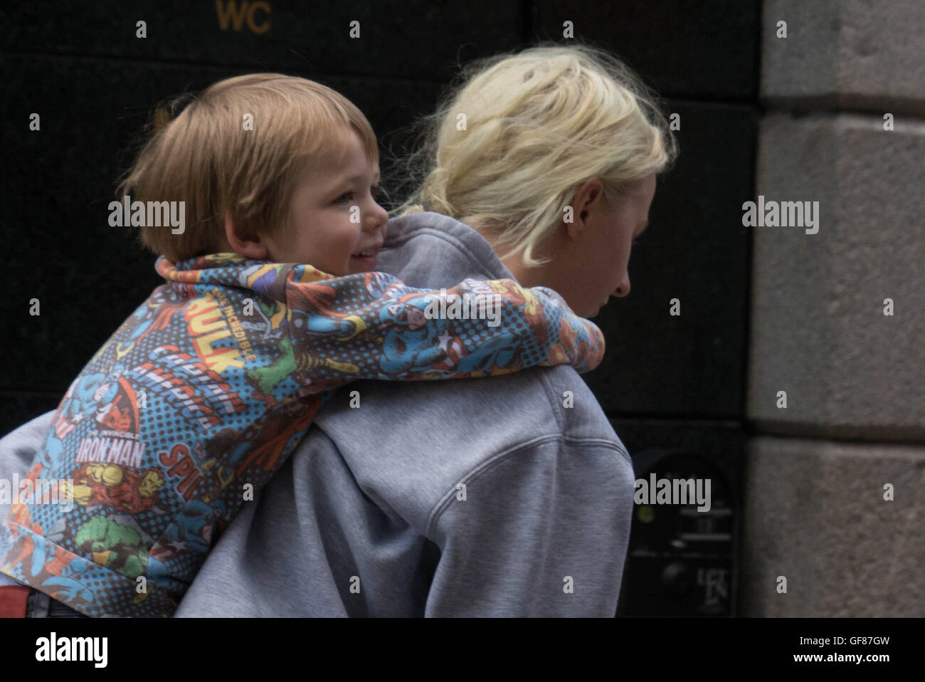 woman carrying young boy on her shoulders Stock Photo