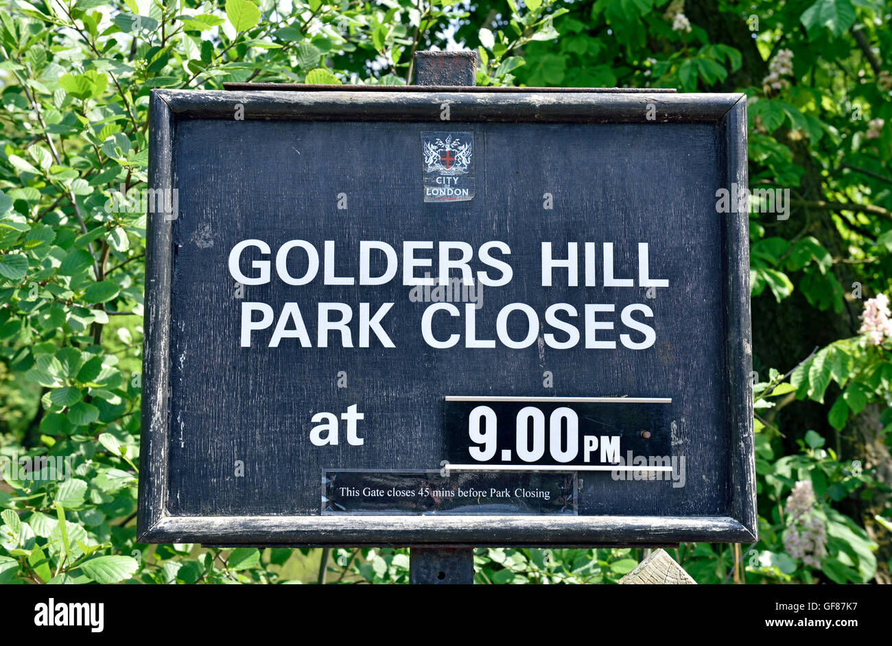 Golders Hill Park sign giving closure time, Golders Green, London England Britain UK Stock Photo