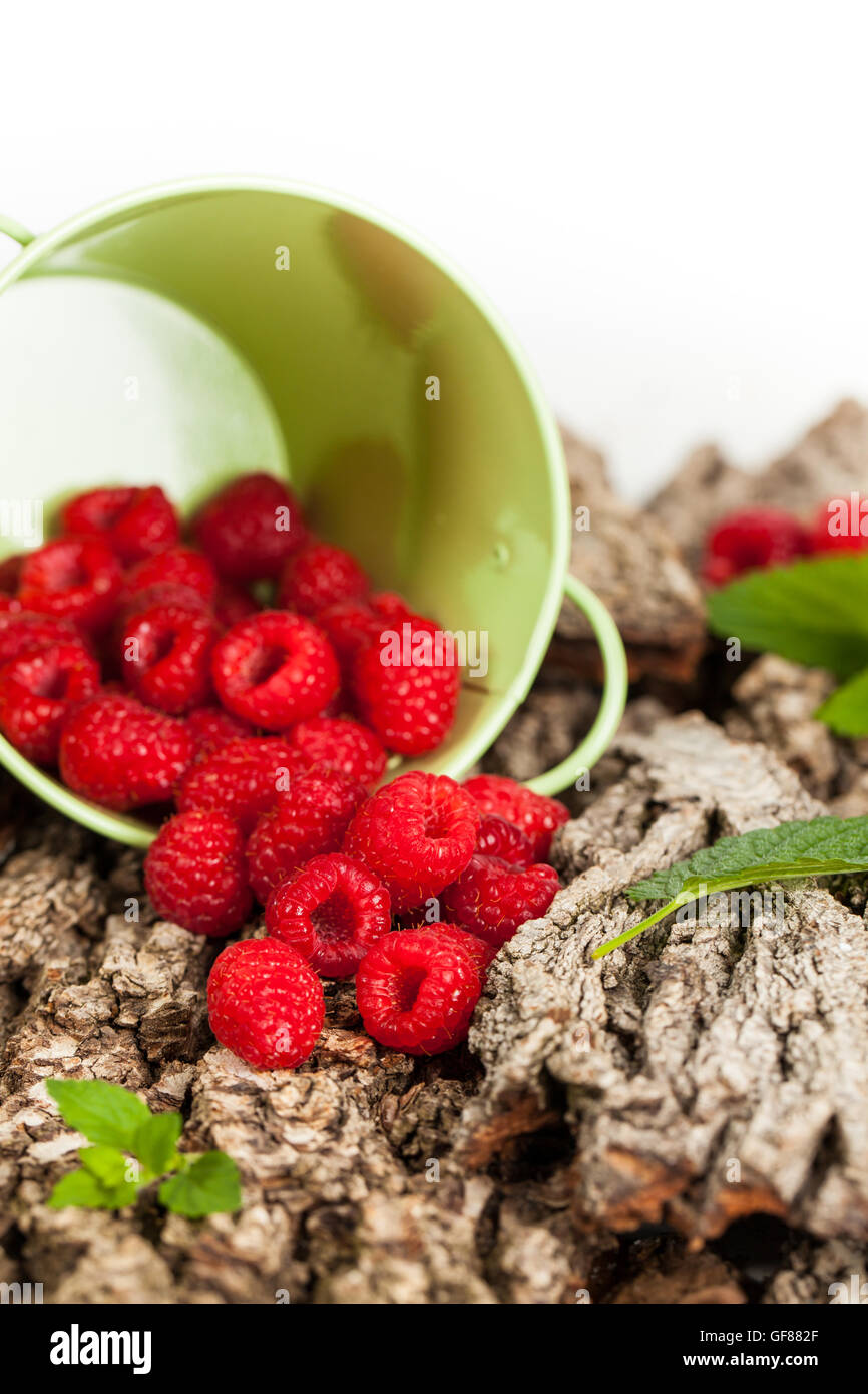 Ripe raspberry with green leaf background Stock Photo - Alamy