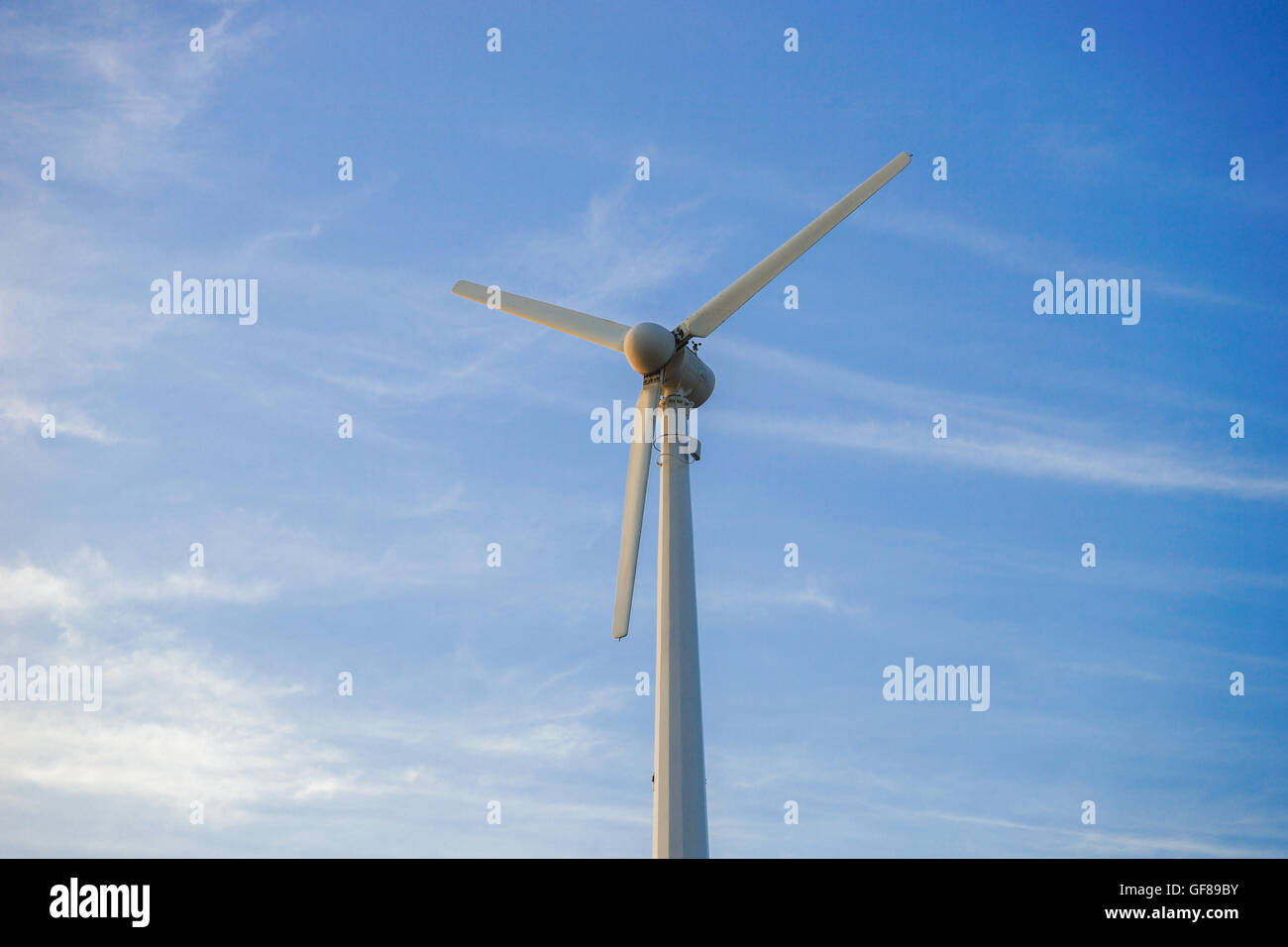 wind turbine against partly cloudy blue sky Stock Photo - Alamy