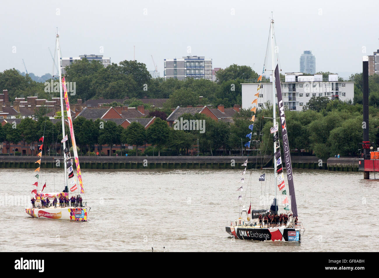 Teams (right-left) LMAX Exchange and Derry-Londonderry-Derry during the final stage of the Clipper Round the World Yacht Race at St Katharine Docks, London. Stock Photo
