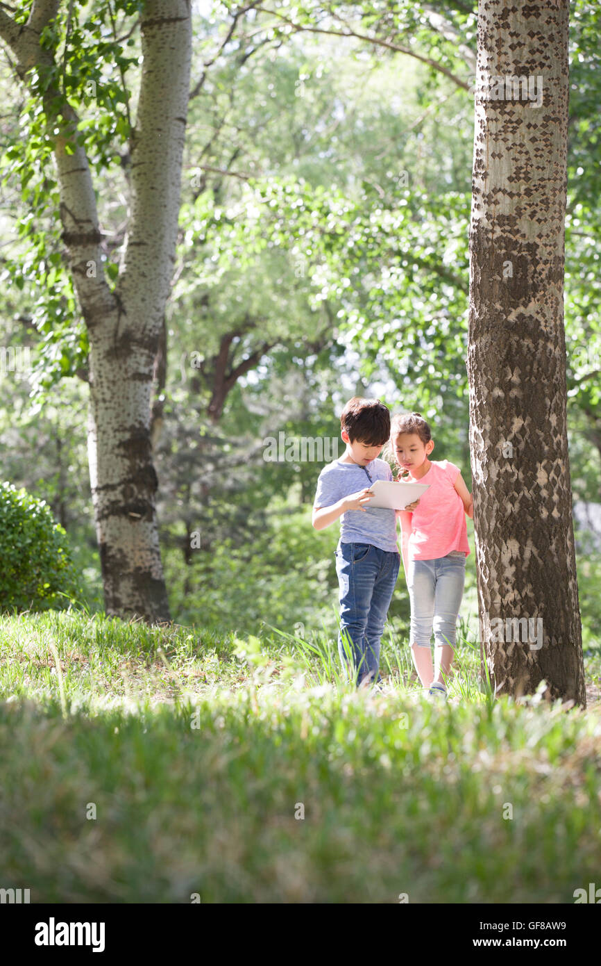 Happy Chinese children playing in woods Stock Photo - Alamy