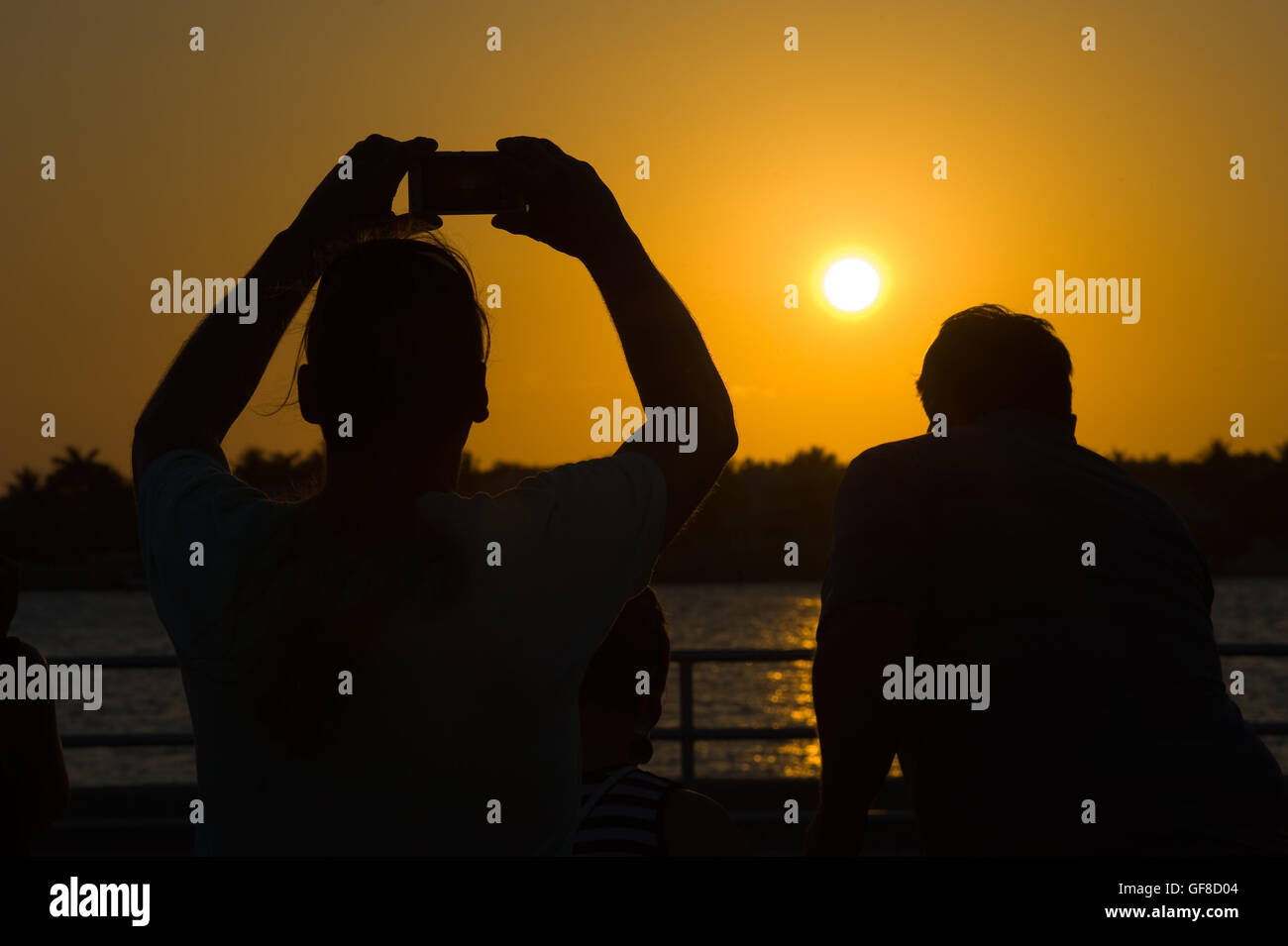 Tourists are making pictures of the sunset in Key West in Florida Stock Photo