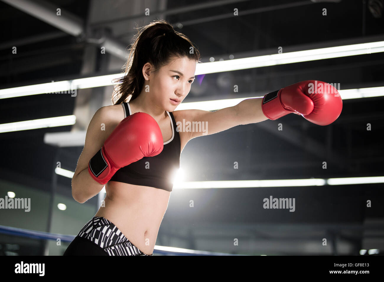 Female Chinese boxer practicing in boxing ring Stock Photo - Alamy