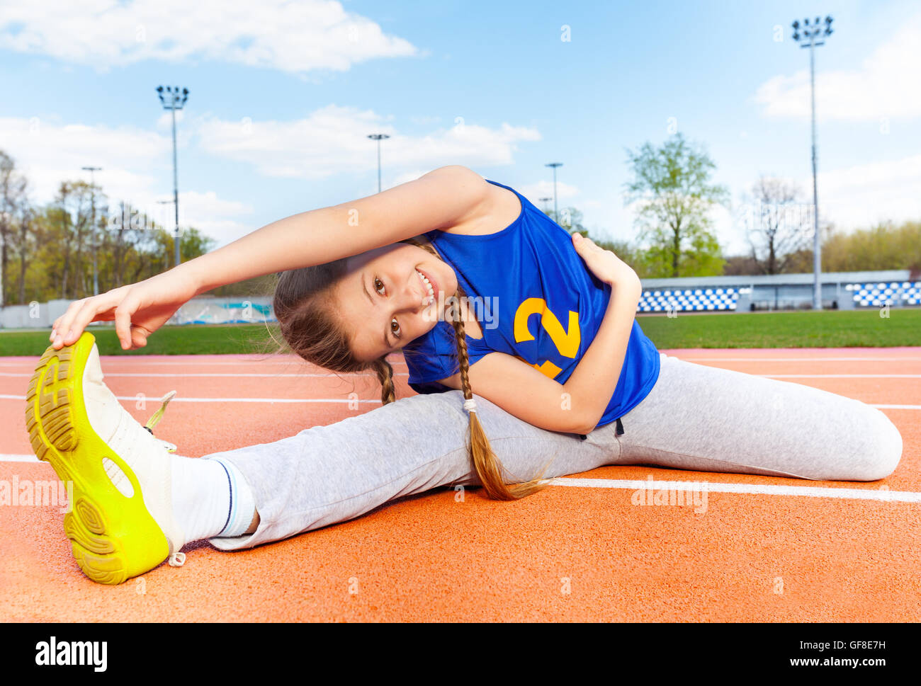 Happy teenage girl making yoga stretching outside Stock Photo - Alamy