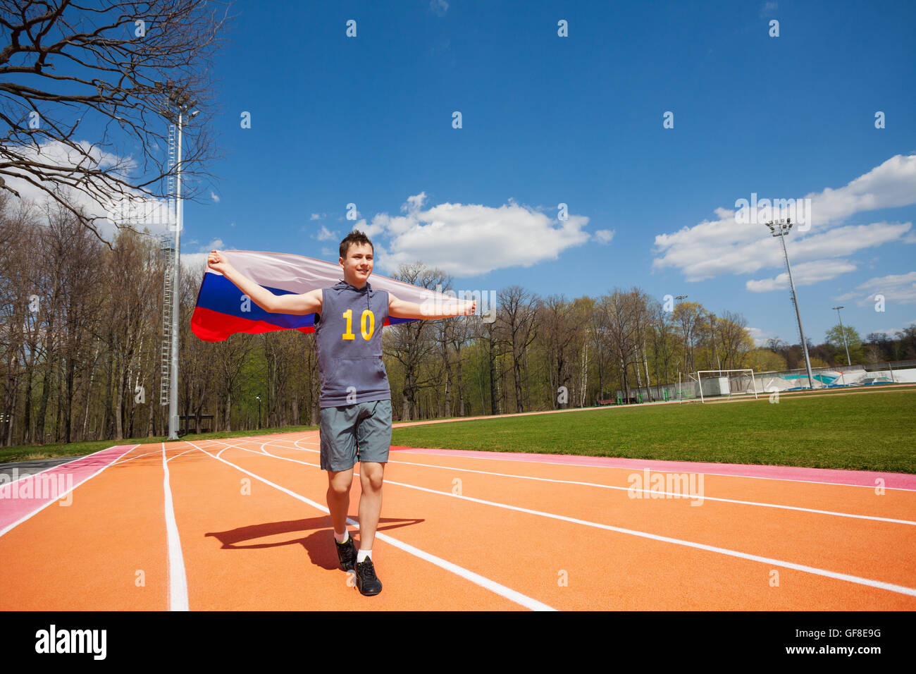 Happy race winner waving Russian flag on the track Stock Photo