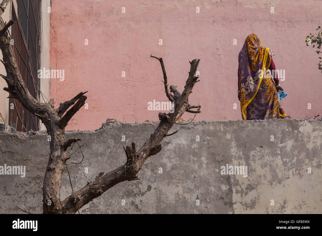An artistic rendering of a Indian woman working on the second floor of a building in New Delhi, India. Stock Photo