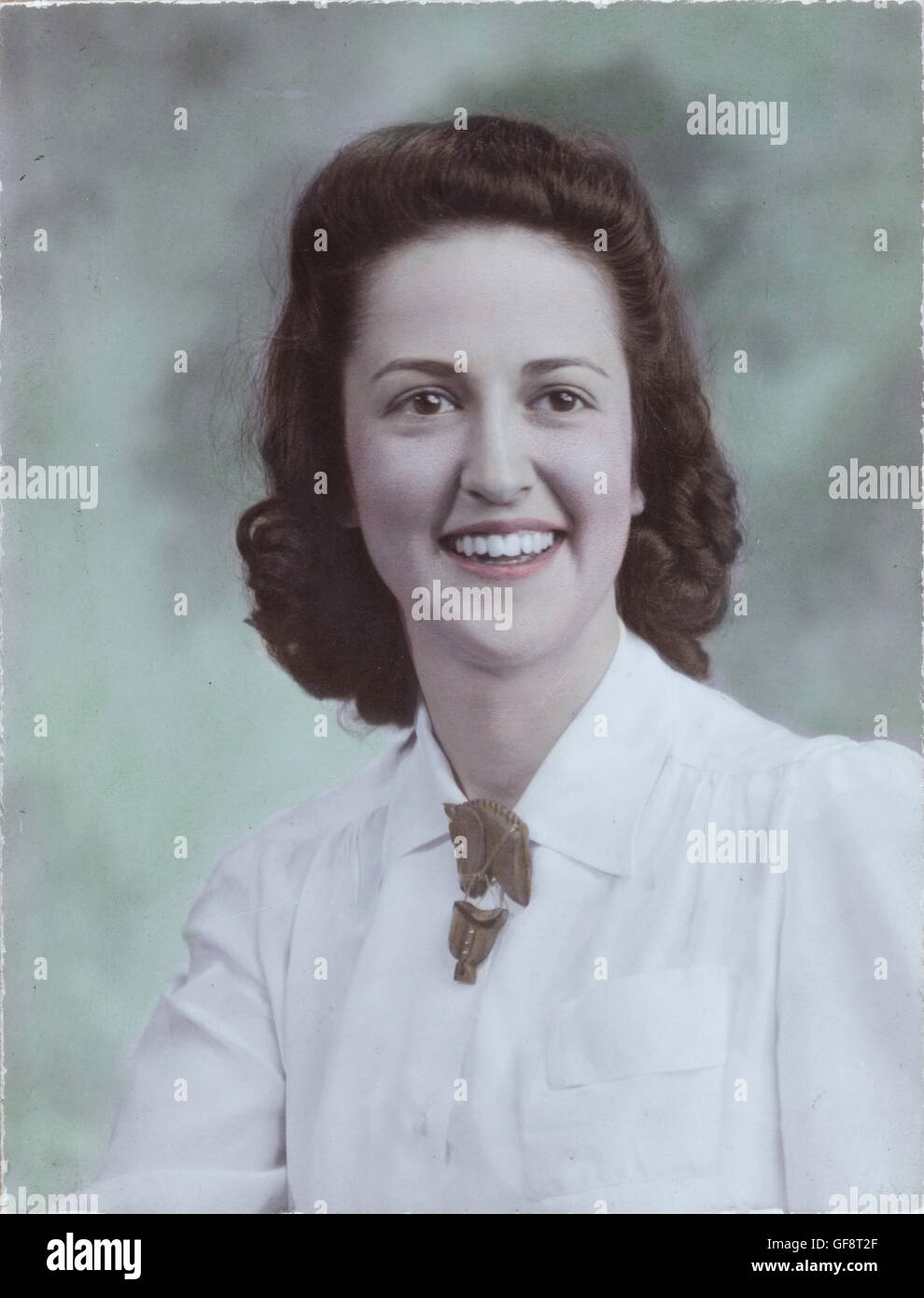 Vintage 1940's Hand Tinted Black and White Portrait, Attractive Smiling Brunette Young Woman, USA Stock Photo