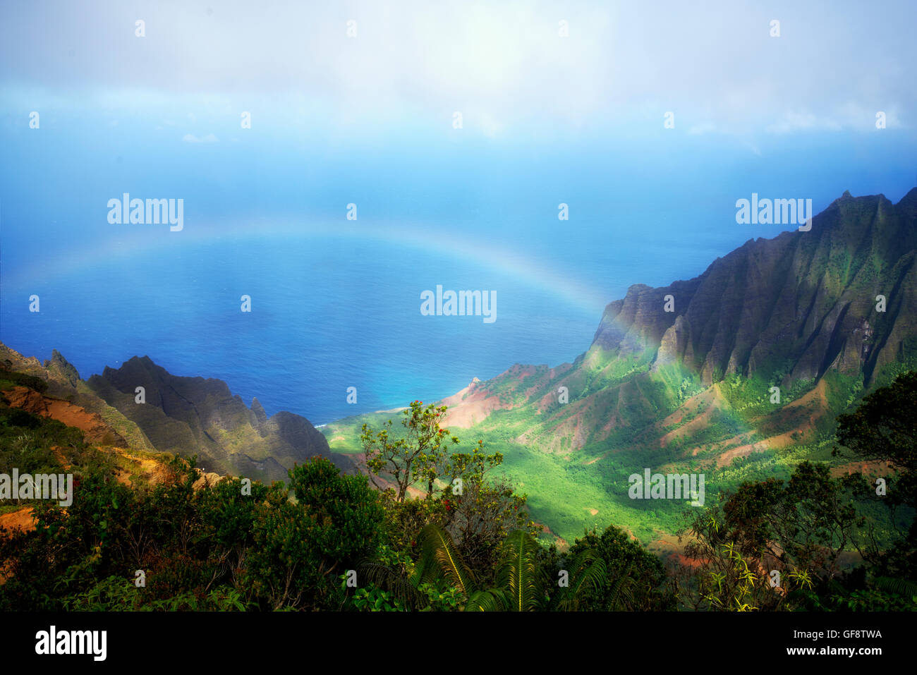 Rainbow as seen from Kalalau Lookout. Waimea Canyon. Kauai, Hawaii Stock Photo