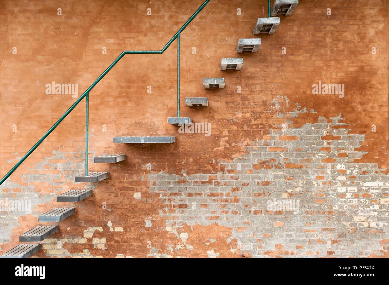 A metal stairway on an orange brickwall Stock Photo