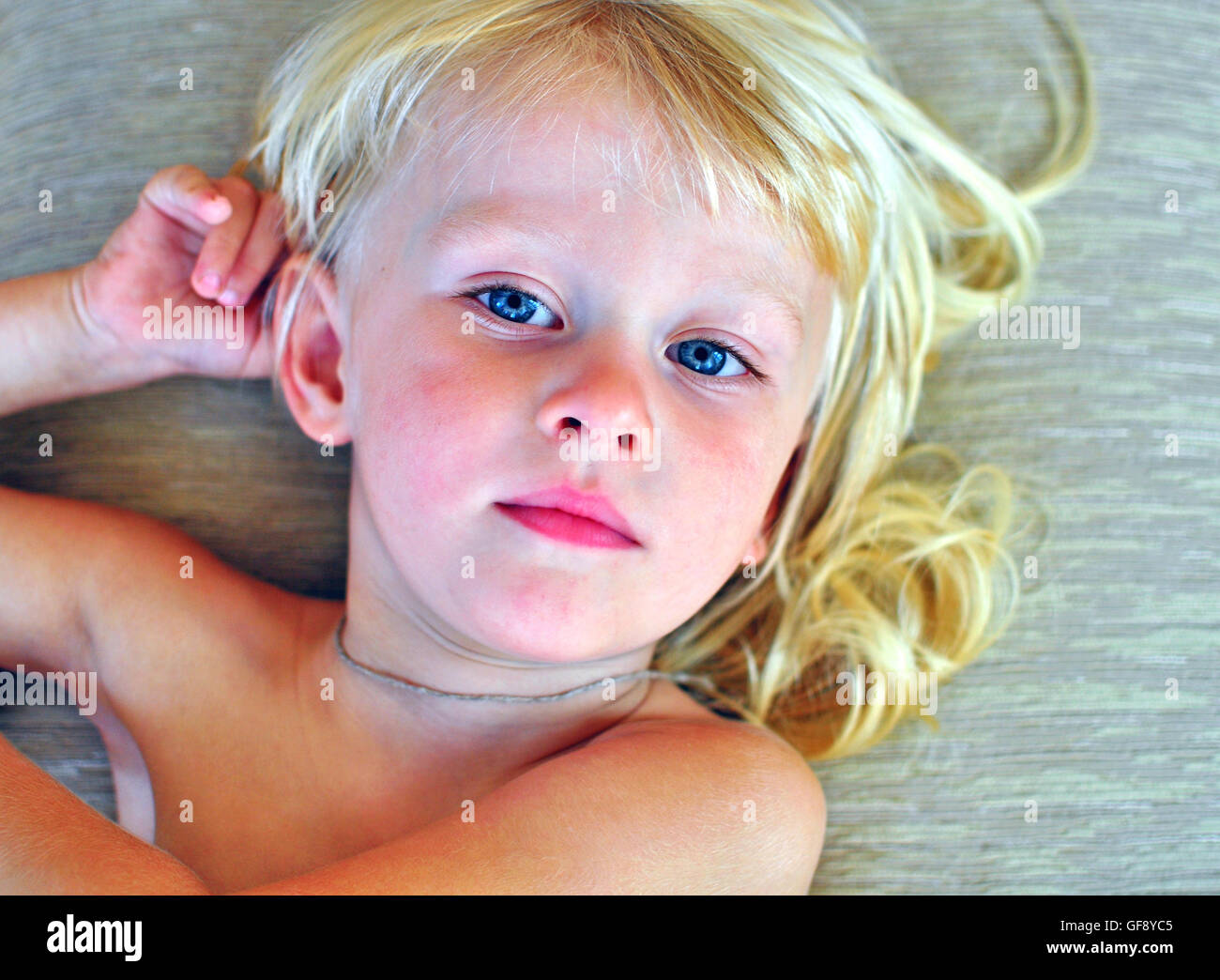 Portrait of a little boy with a long blonde hair Stock Photo