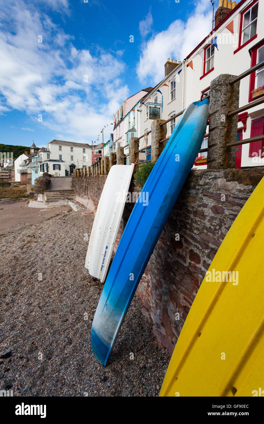 Canoes and boats leaning against the coastal wall at Kingsand, Cornwall
