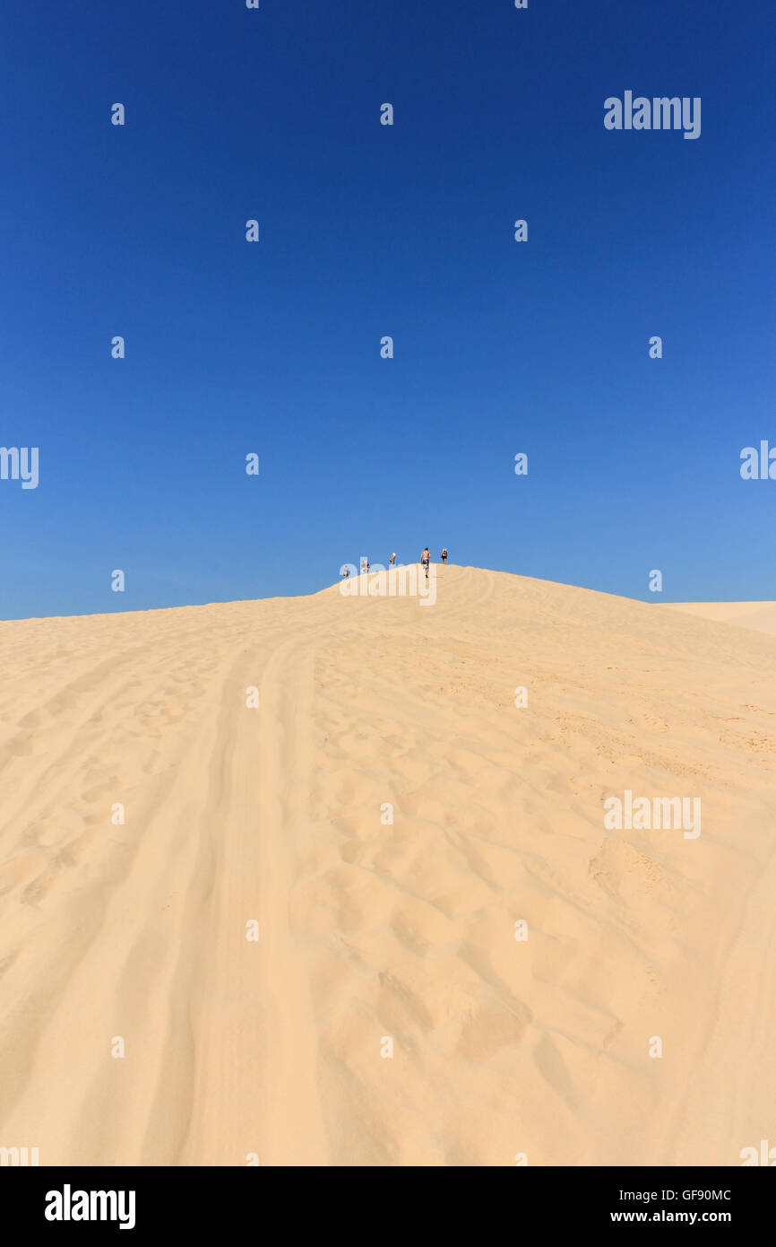 people in desert at white sand dune in mui ne , vietnam Stock Photo