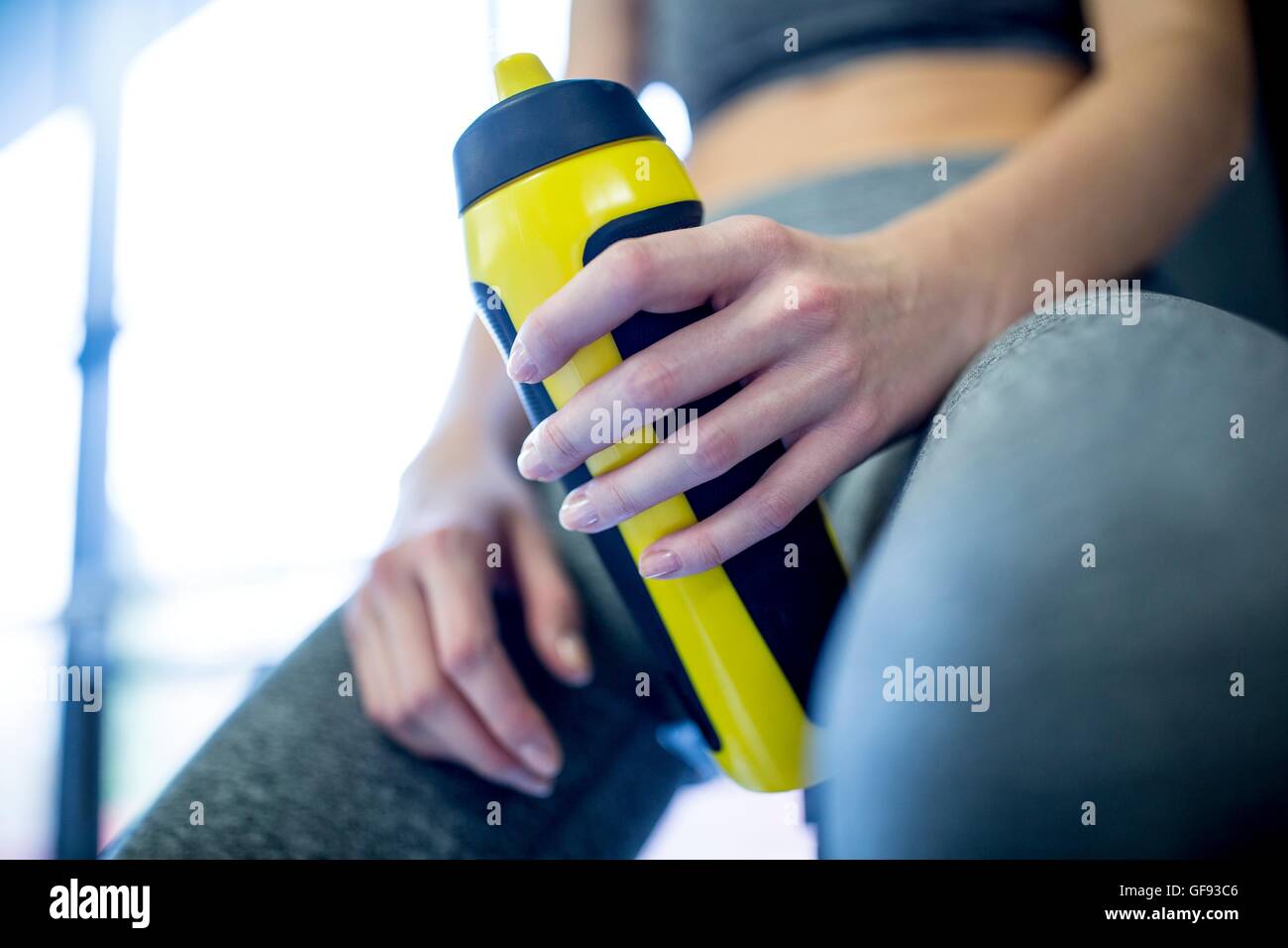 PROPERTY RELEASED. MODEL RELEASED. Woman holding water bottle in gym, close-up. Stock Photo