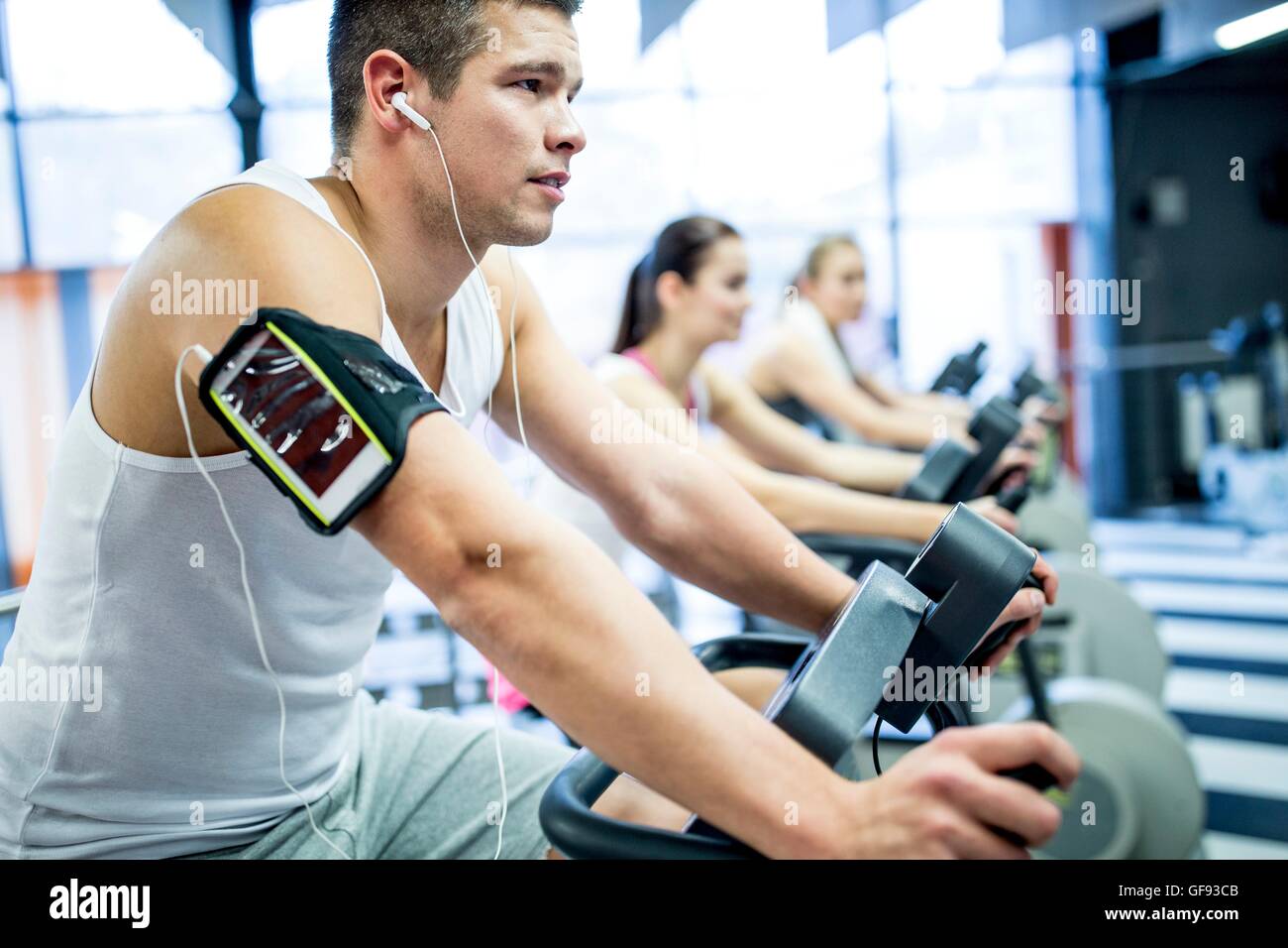 PROPERTY RELEASED. MODEL RELEASED. Young man listening to music while work out in gym. Stock Photo