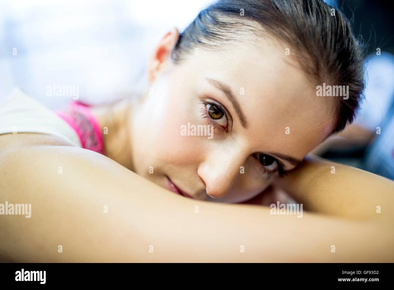 PROPERTY RELEASED. MODEL RELEASED. Close-up of young woman resting on exercise machine in gym, portrait. Stock Photo