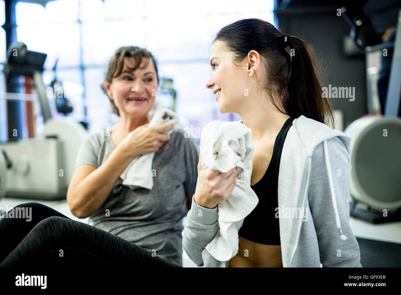 PROPERTY RELEASED. MODEL RELEASED. Woman talking with each other after workout in gym. Stock Photo