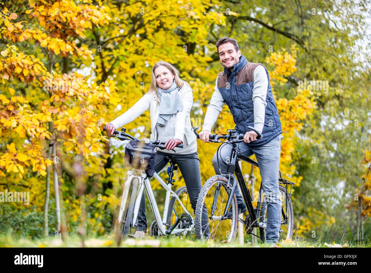 MODEL RELEASED. Young couple cycling together. Stock Photo
