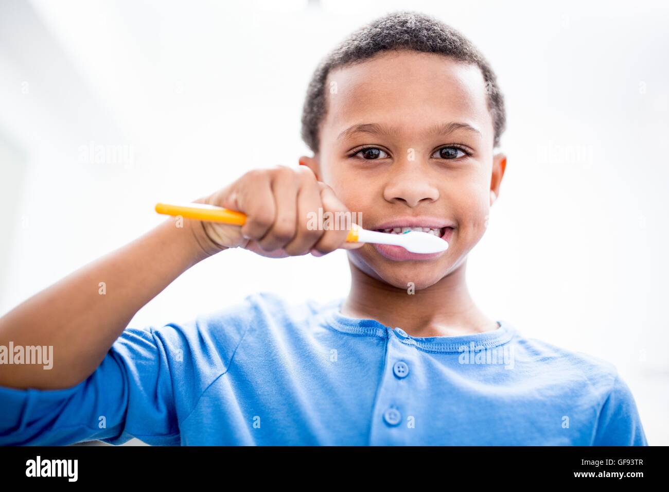 MODEL RELEASED. Boy brushing teeth, portrait, close-up. Stock Photo