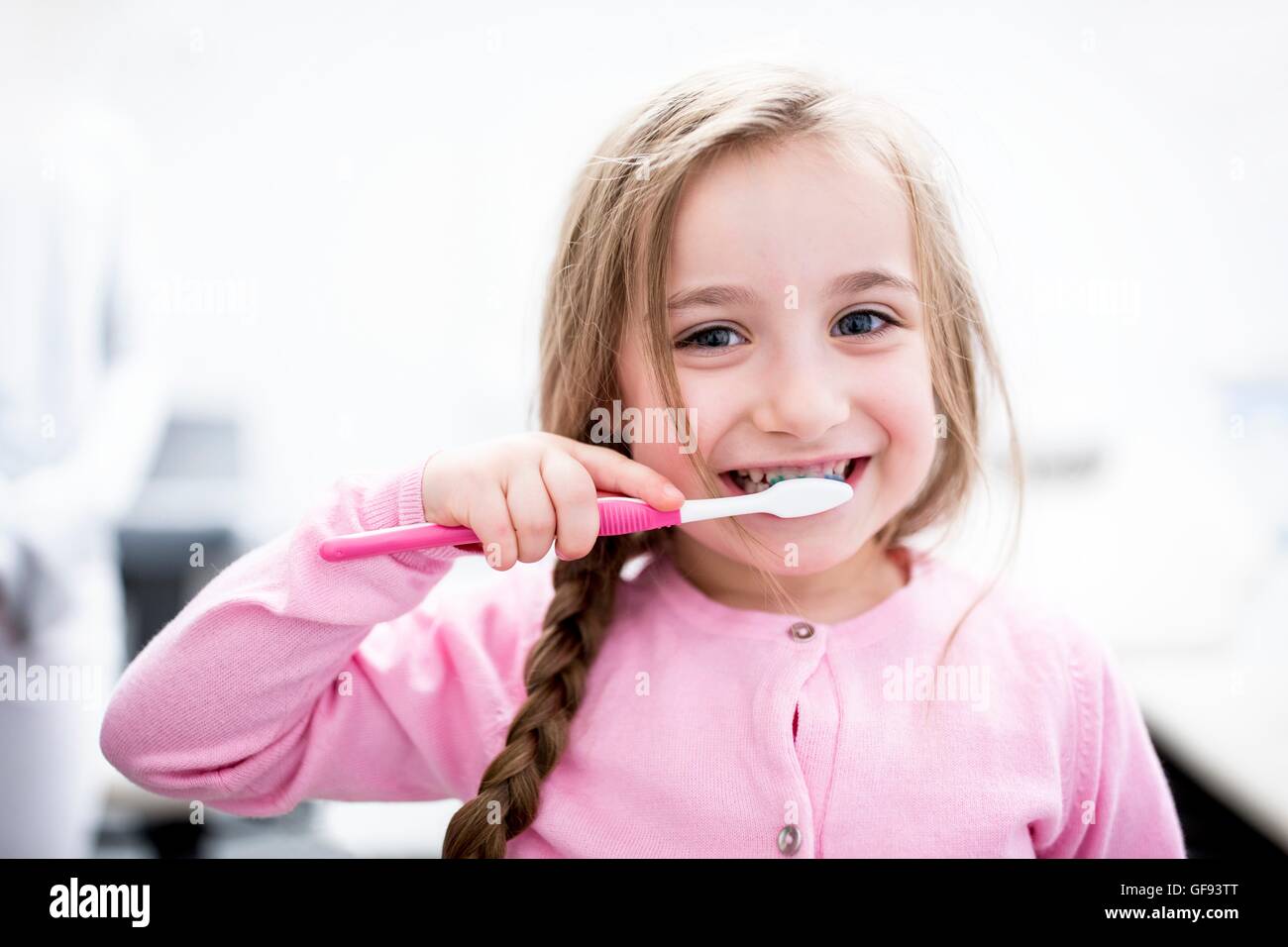 MODEL RELEASED. Girl brushing teeth, portrait, close-up. Stock Photo