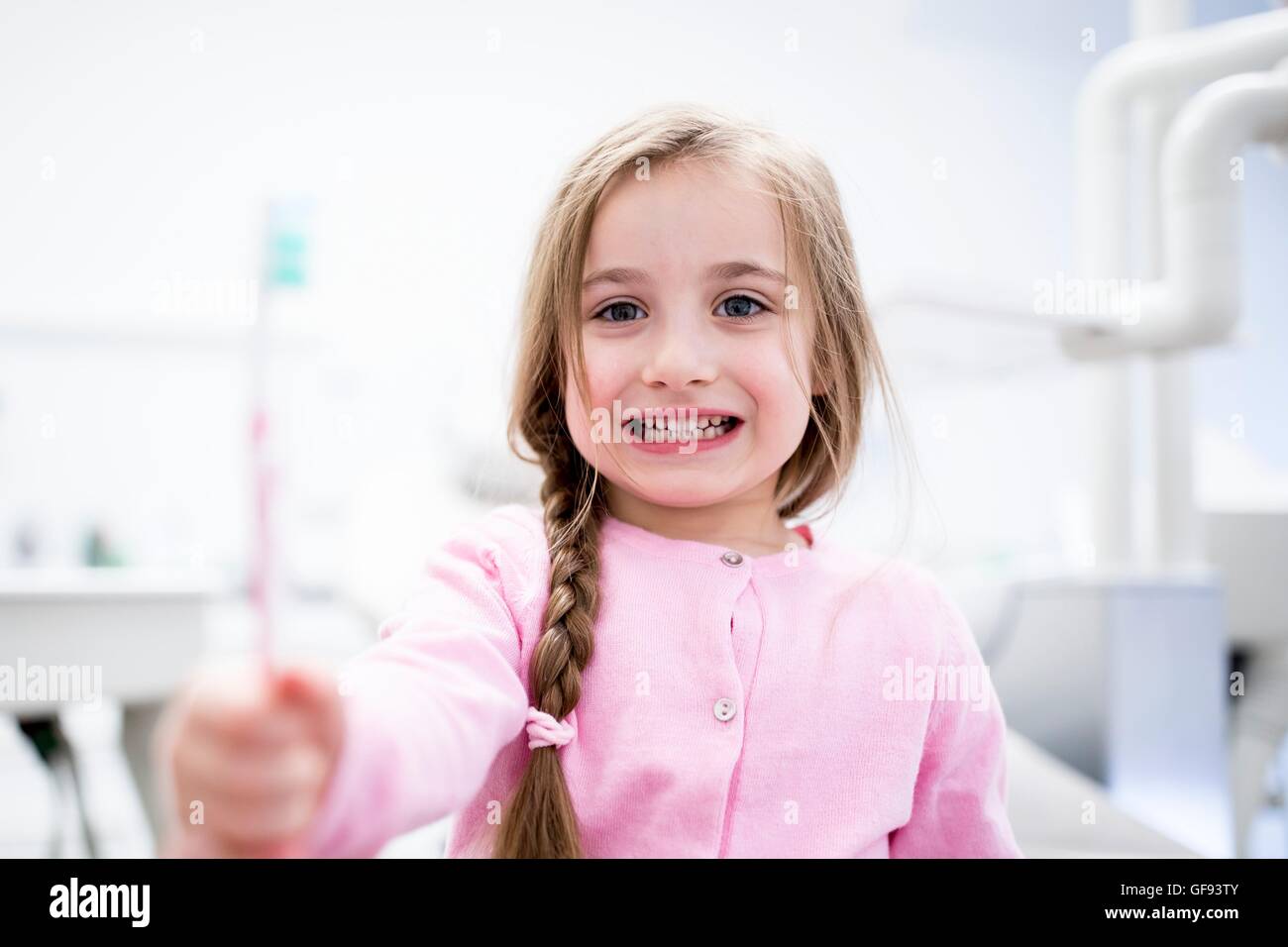 MODEL RELEASED. Close-up of girl holding toothbrush. Stock Photo