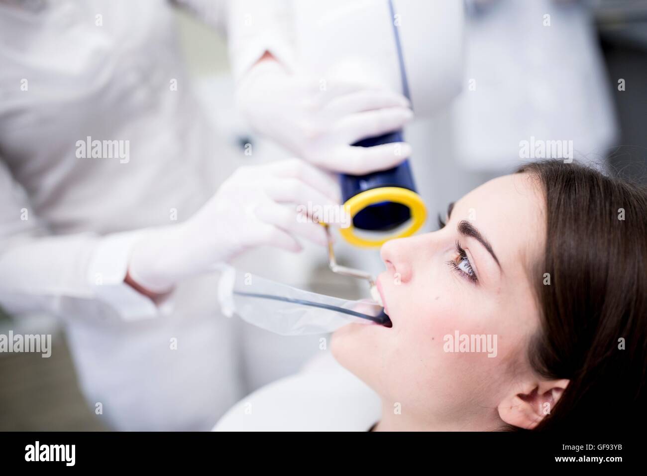 MODEL RELEASED. Young woman having dental x-ray in clinic. Stock Photo