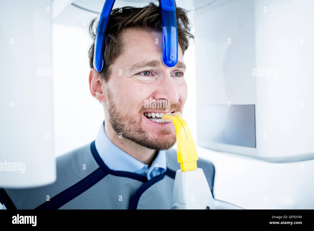 MODEL RELEASED. Mid adult man having x-ray in clinic. Stock Photo