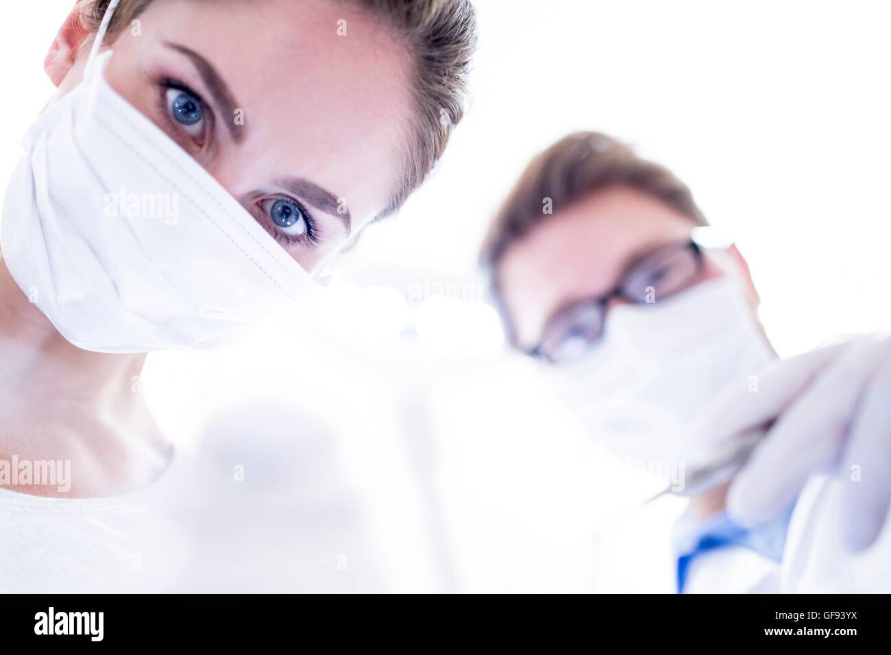 MODEL RELEASED. Dentist and dental assistant holding angled mirror. Stock Photo