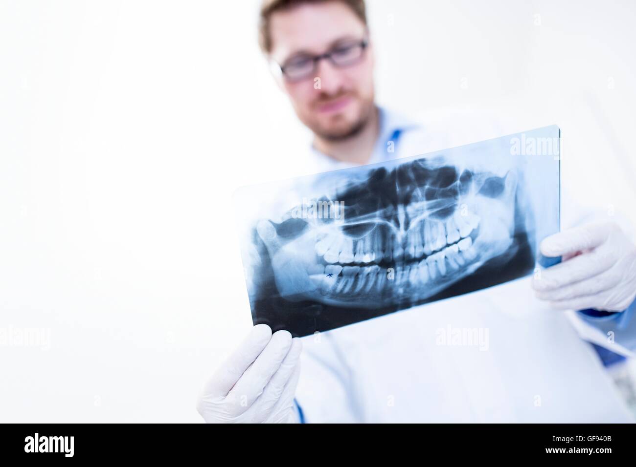 MODEL RELEASED. Dentist and dental assistant looking at x-ray image. Stock Photo