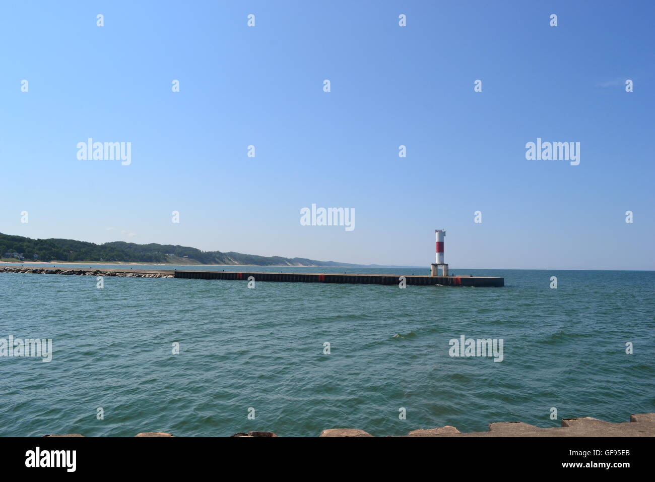 Pier on Lake Michigan, blue water and blue sky. Stock Photo