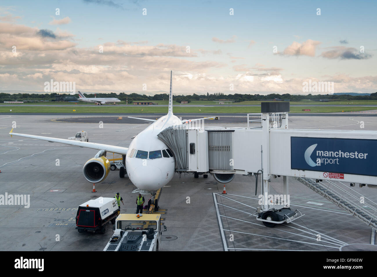 An airliner is stationery on the apron of Manchester Airport while passengers board and luggage is loaded (Editorial use only). Stock Photo