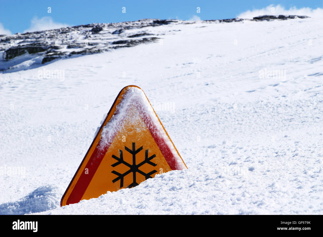 snow danger sign covered in snow Stock Photo