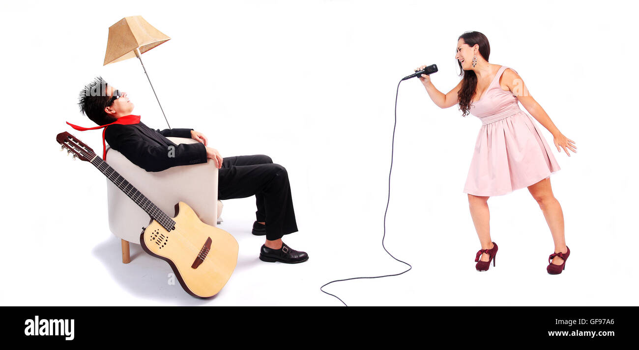 A female singer and a male guitarrist in action in white background. The musician is blown away by the powerful voice of the sin Stock Photo