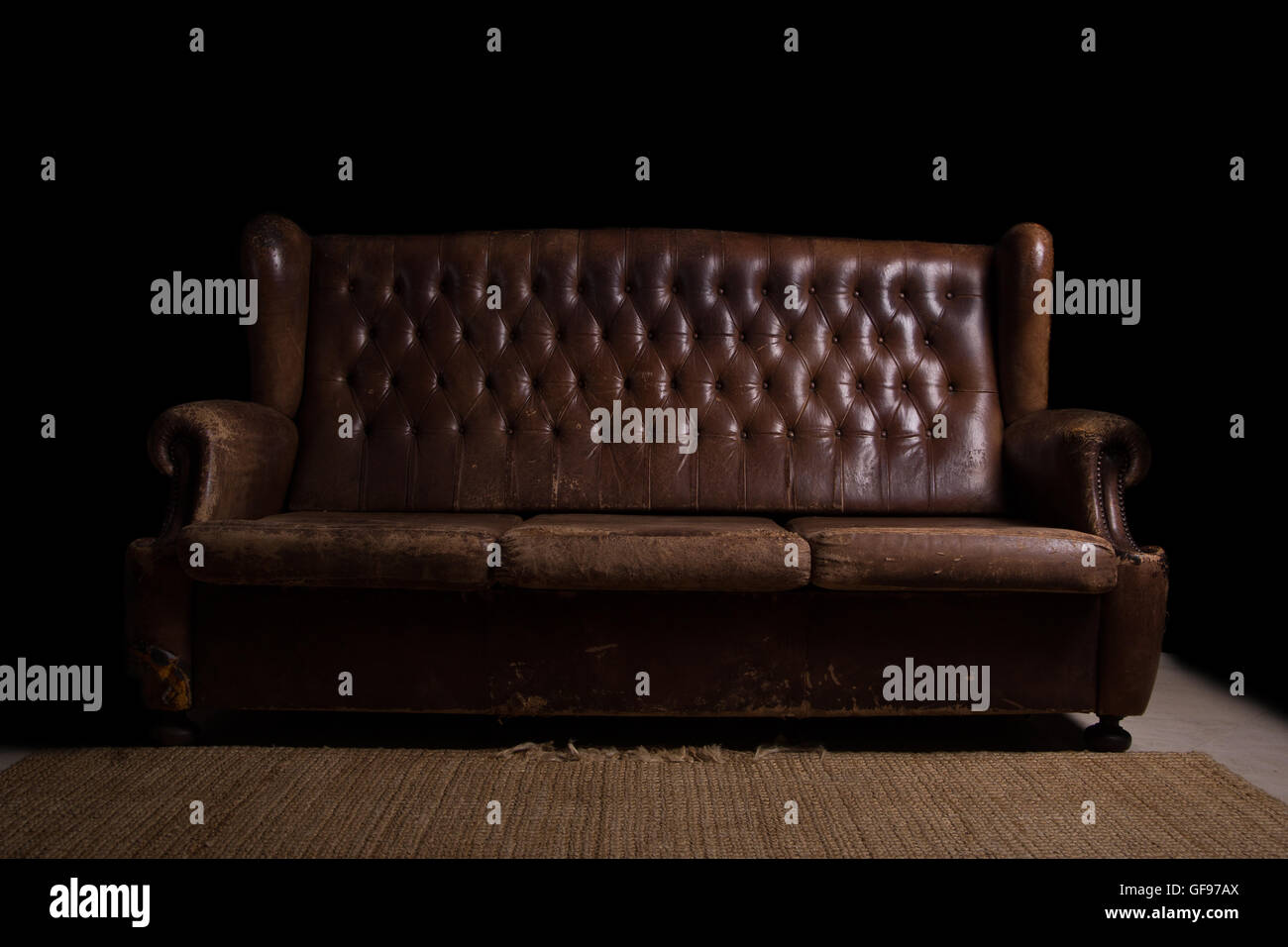 Vintage couch with a black background. Grunge style Stock Photo