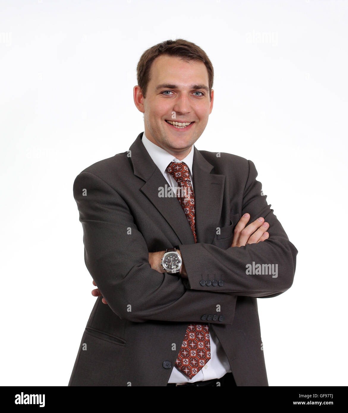 Portrait of young businessman standing against isolated white ...