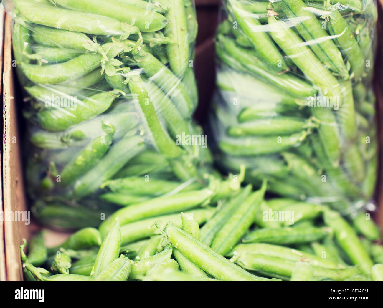 close up of green peas in box at street market Stock Photo