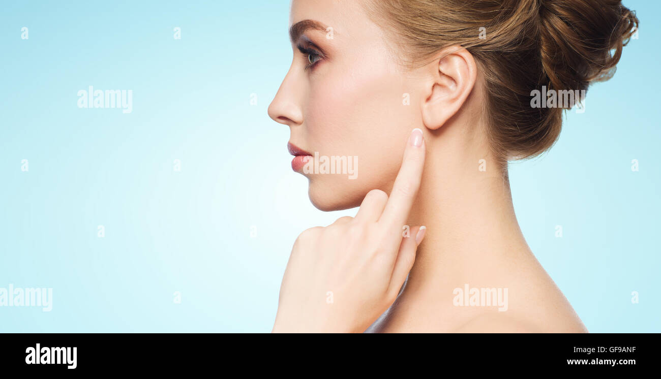 beautiful woman pointing finger to her ear Stock Photo - Alamy