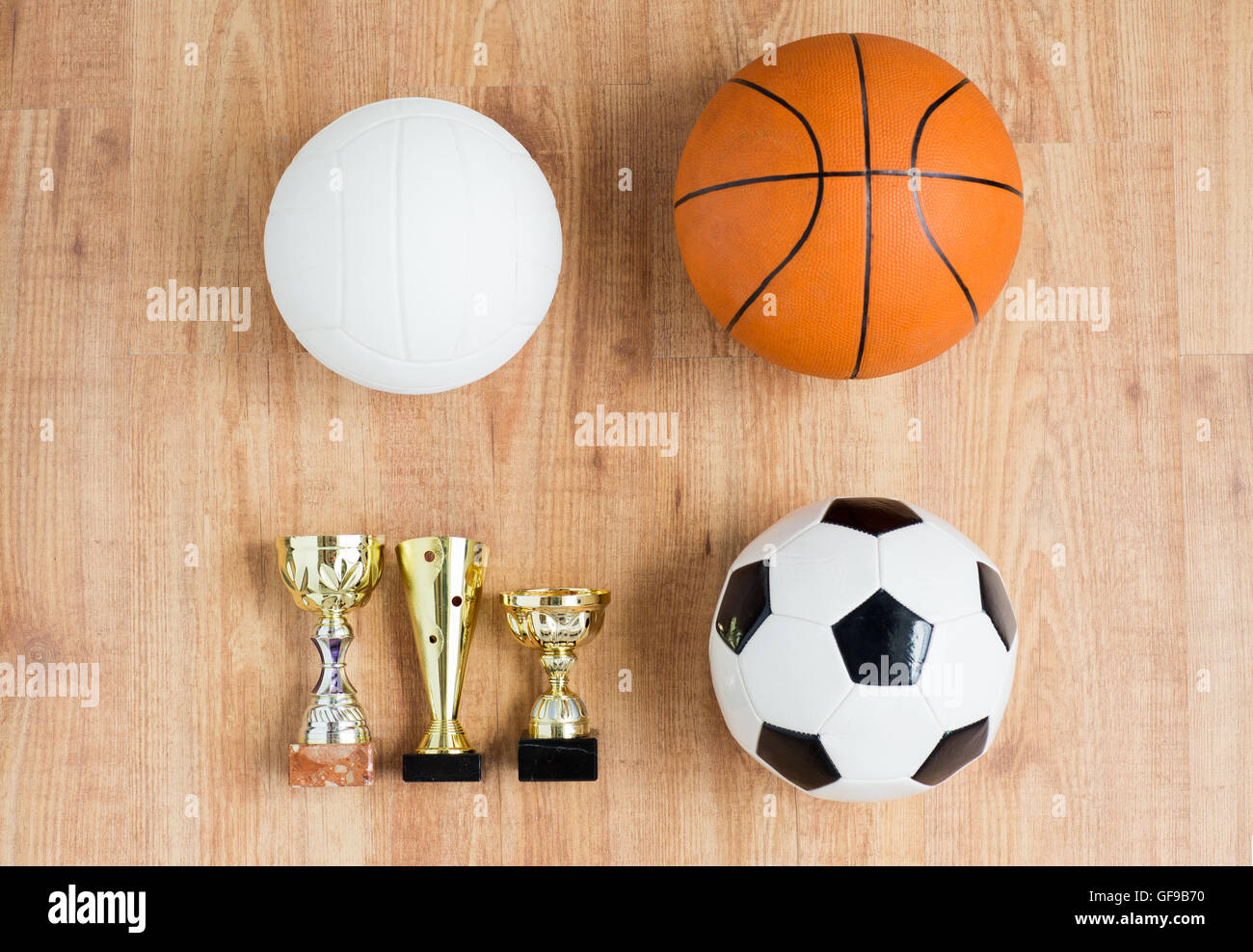 football, basketball, volleyball balls and cups Stock Photo