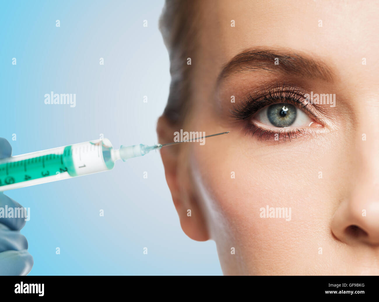 woman face and hand with syringe making injection Stock Photo - Alamy