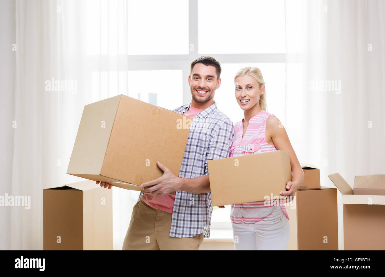 couple with big cardboard boxes moving to new home Stock Photo - Alamy