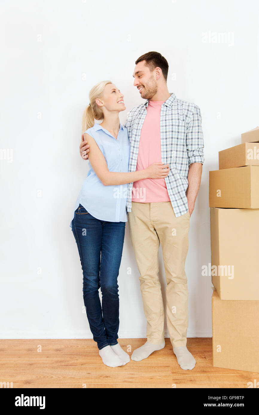 couple with cardboard boxes moving to new home Stock Photo - Alamy