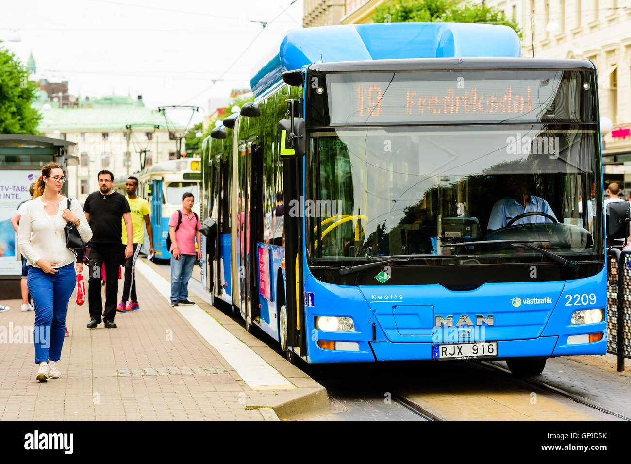 Goteborg, Sweden - July 25, 2016: Real people in everyday life. A blue compressed natural gas (CNG) fueled bus has stopped to le Stock Photo