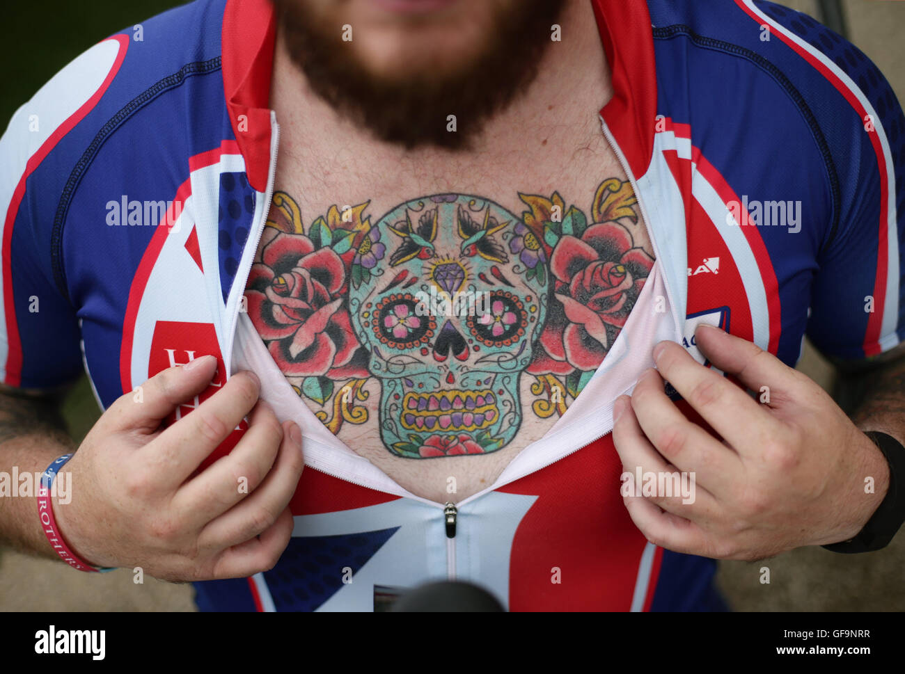 Competitor Clive Smith shows off his chest tattoo during the Prudential RideLondon Grand Prix at the Lee Valley VeloPark, Queen Elizabeth Olympic Park, in London. Stock Photo